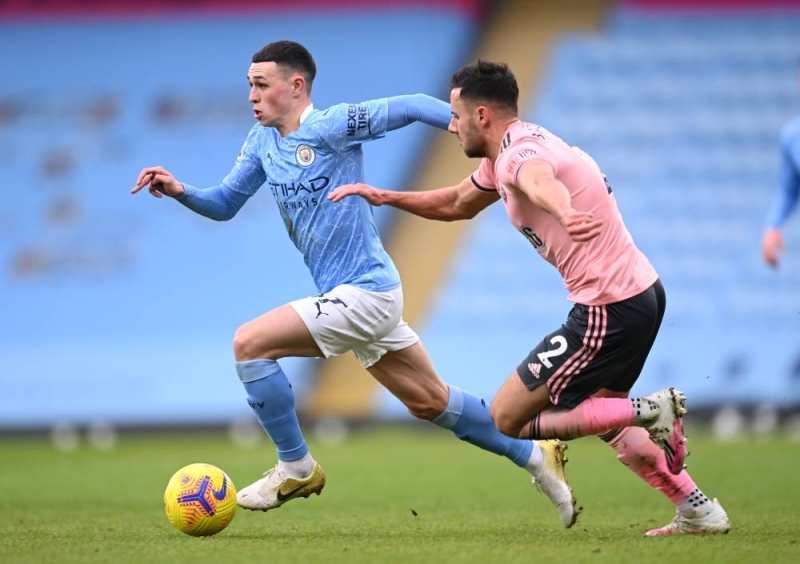 Manchester City's Phil Foden in action with Sheffield United's George Baldock. Photo: Reuters

