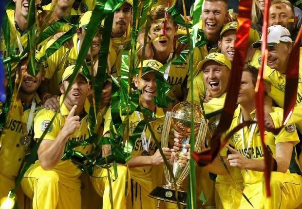 Australia's captain Michael Clarke (C) holds the Cricket World Cup trophy as he celebrates with team mates and support staff after they defeated New Zealand in the final match at the Melbourne Cricket Ground (MCG) March 29, 2015. REUTERS/Jason Reed