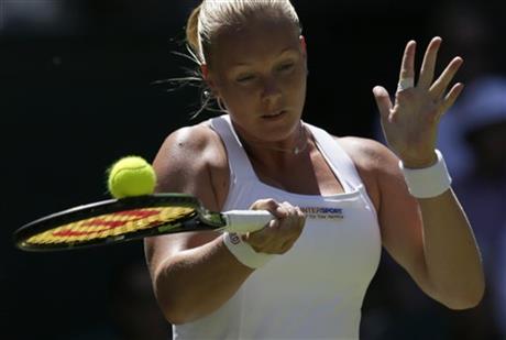Kiki Bertens of the Netherlands returns a ball to Petra Kvitova of the Czech Republic during the singles first round match at the All England Lawn Tennis Championships in Wimbledon, London, Tuesday June 30, 2015. AP