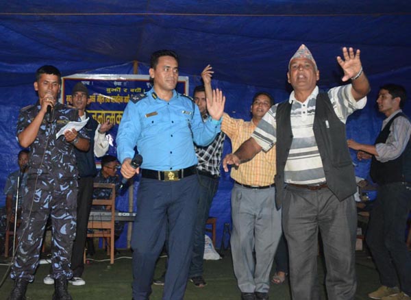 Artistes from Nepal Police Music School performing a dance with locals at a programme organised to prevent possible violence and trafficking of women and children in the post-quake scenario, in Dhading, on Monday. nPhoto: THT