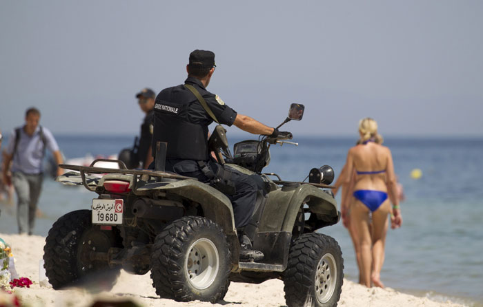 A police officer patrols the beach near the Imperial Marhaba resort, which was attacked by a gunman in Sousse, Tunisia, June 29, 2015. The gunman disguised as a tourist opened fire at the Tunisian hotel last Friday with a rifle he had hidden in an umbrella, killing 39 people including Britons, Germans and Belgians as they lounged at the beach in an attack claimed by Islamic State. Photo: Reuters