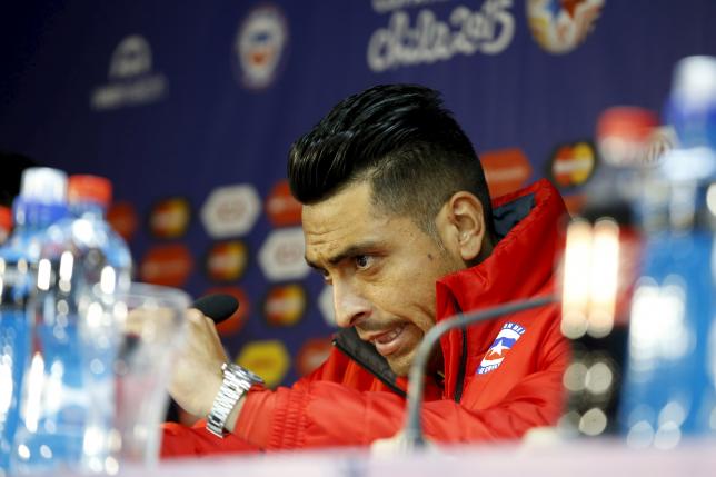 Chile's player Gonzalo Jara and coach Jorge Sampaoli (not pictured) attend a news conference ahead of the Copa America tournament in Santiago City, June 14, 2015. REUTERS/Ivan Alvarado