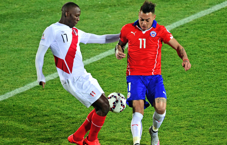 Peru's Luis Advincula (left) vies for the ball with Chile's Eduardo Vargas during their Copa America semi-final match in Santiago on Monday. Chile won 2-1. Photo: AFP