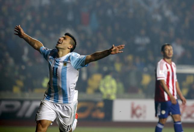 Argentina's Sergio Aguero celebrates after scoring a goal as Paraguay's Ivan Piris looks on during their Copa America 2015 semi-final soccer match at Estadio Municipal Alcaldesa Ester Roa Rebolledo in Concepcion, Chile, June 30, 2015. REUTERS/Andres Stapff