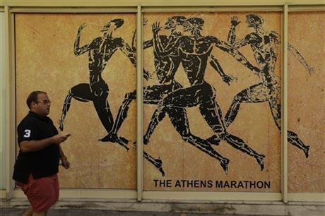 A man passes a store front of souvenir shop in the Plaka tourist district of Athens, Tuesday, July 28, 2015. AP