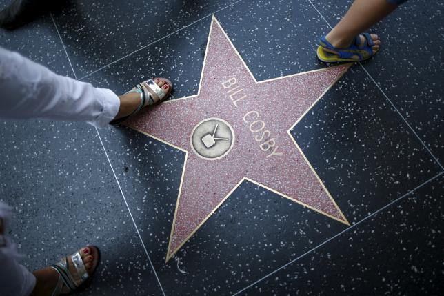 People walk over Bill Cosby's star of the Hollywood Walk of Fame in Los Angeles, California, United States July 9, 2015. REUTERS/Lucy Nicholson