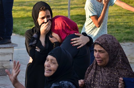 Egyptian women mourn for victims of a passenger boat after it sunk in the river Nile in Giza, south of Cairo, Egypt, Thursday, July 23, 2015. Egypt's Interior ministry says more than a dozen civilians have drowned when the passenger boat traveling down the Nile near Cairo collided with a scow, causing the boat to capsize. (AP Photo/Samer Abdullah)