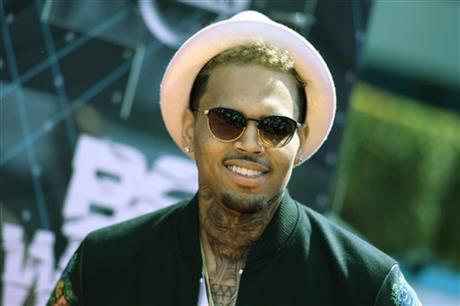 FILE - In this June 28, 2015 file photo, Chris Brown arrives at the BET Awards at the Microsoft Theater in Los Angeles. Grammy award-winning singer Brownu2019s departure from Manila has been delayed because of a fraud complaint against him and his promoter for a canceled concert last New Yearu2019s eve.  AP