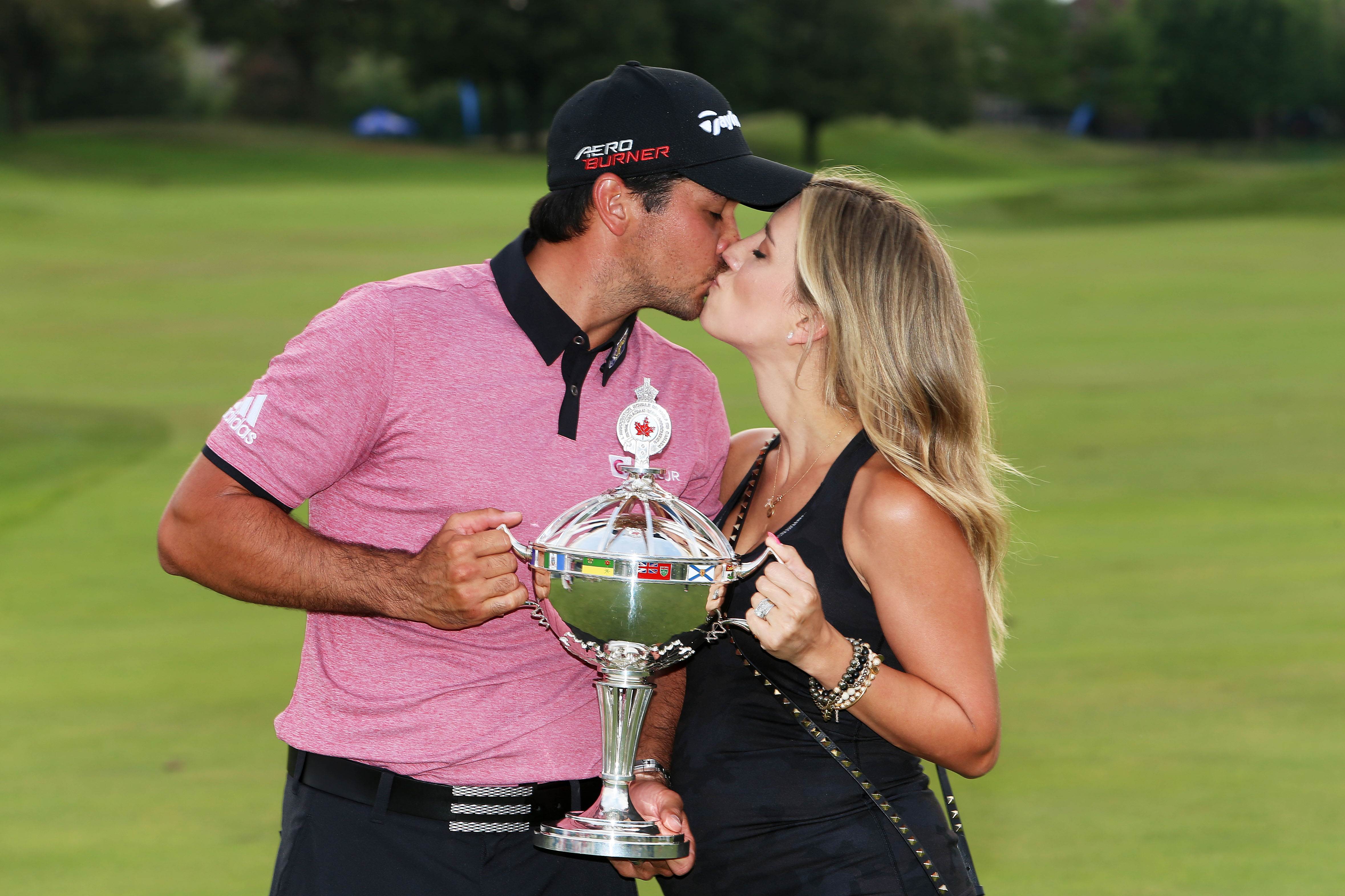 Australia's Jason Day celebrates the winner's trophy with his wife after winning the RBC Canadian Open at the Glen Abbey Golf Club in Oakville on Sunday. Photo: AFP