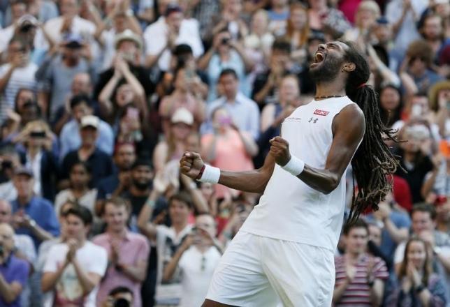 Dustin Brown of Germany celebrates after winning his match against Rafael Nadal of Spain at the Wimbledon Tennis Championships in London, July 2, 2015.           REUTERS/Stefan Wermuth