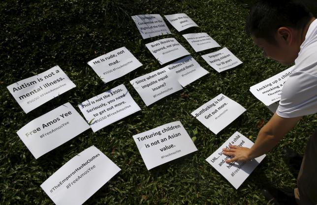 Organiser Jolovan Wham lays out placards during a protest to free blogger Amos Yee, at Hong Lim Park in Singapore July 5, 2015. REUTERS/Edgar Su