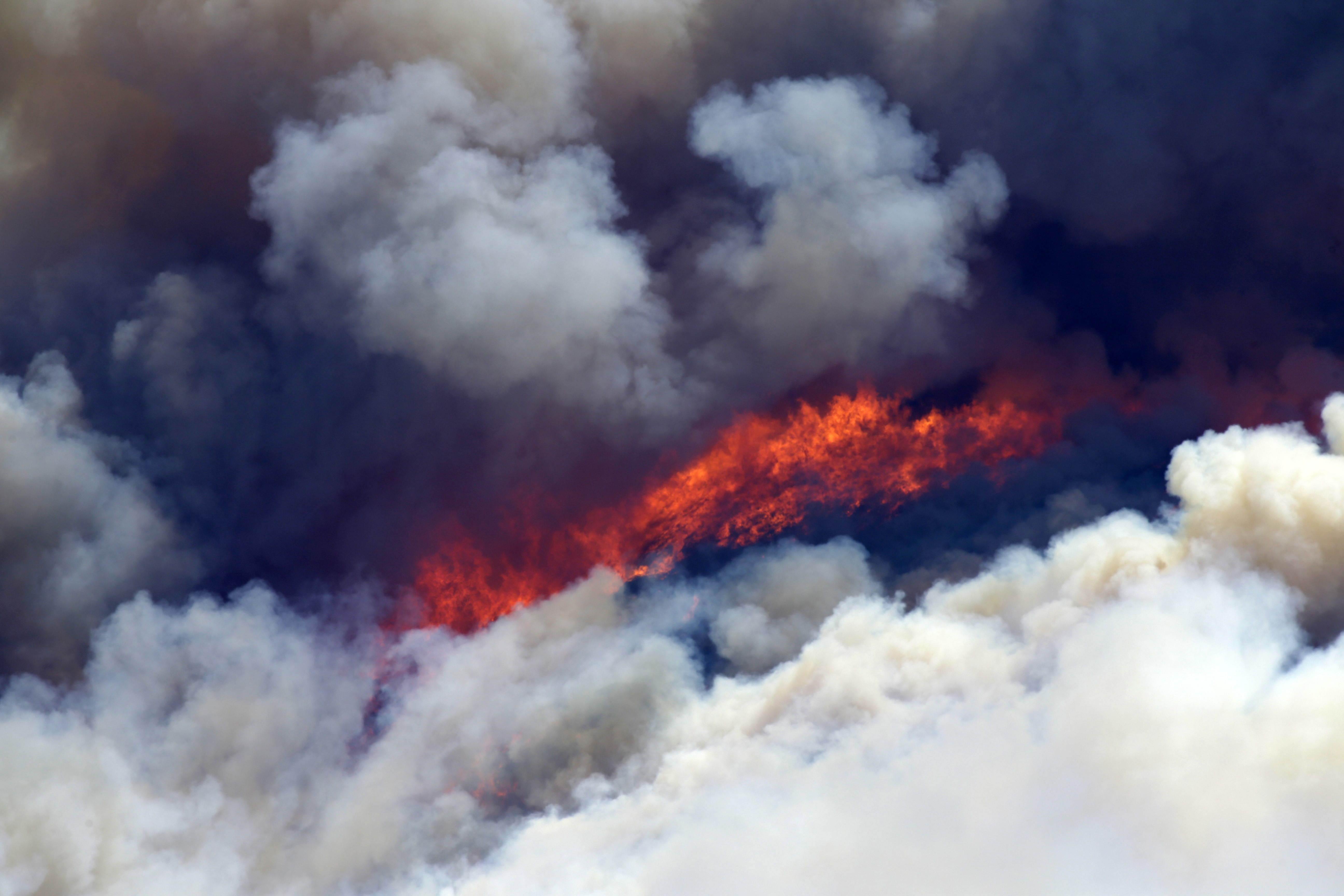 A fire burns on the mountain of Ymittos, in the eastern suburbs of Athens on Friday, July 17, 2015. The brush fire broke out on the outskirts of the Greek capital, burning across a hillside and blanketing parts of Athens in thick smoke. The blaze moved fast, fanned by strong winds and devouring parts of a verdant hillside popular with day-trippers. Photo: AP