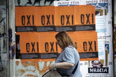 A woman passes in front of posters reading ''NO'' referring to the upcoming referendum, in Athens, Wednesday, July 1, 2015. Greece's government pressed ahead Wednesday with its plan to put austerity measures to voters after European creditors rebuffed its latest proposal for a new aid program. AP