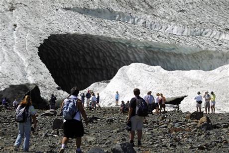 In this July 2010 photo, visitors examine the Big Four Ice Caves in the Mt. Baker-Snoqualmie National Forest near Granite Falls, Wash. The Snohomish County sheriff's office says rescuers responded to a report of a partial collapse of the ice caves Monday, July 6, 2015. AP