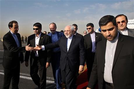 Iran's Foreign Minister Mohammad Javad Zarif, who is also Iran's top nuclear negotiator, center, shakes hands with an official upon arrival at the Mehrabad airport in Tehran, Iran, Wednesday, July 15, 2015. Zarif and his entourage returned to Tehran on Wednesday morning, a day after Iran and the West reached a historic nuclear deal. AP