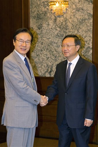 Japanese National Security Adviser Shotaro Yachi, left, shakes hands with Chinese State Councilor Yang Jiechi during a meeting at the Diaoyutai State guesthouse in Beijing, Thursday, July 16, 2015. (AP Photo/Ng Han Guan, Pool)