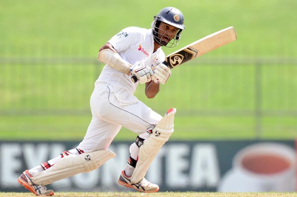 Sri Lankau0092s Dimuth Karunaratne plays a shot against Pakistan during the opening day of their third and final Test match at the Pallekele International Cricket Stadium on Friday. Photo: AFP