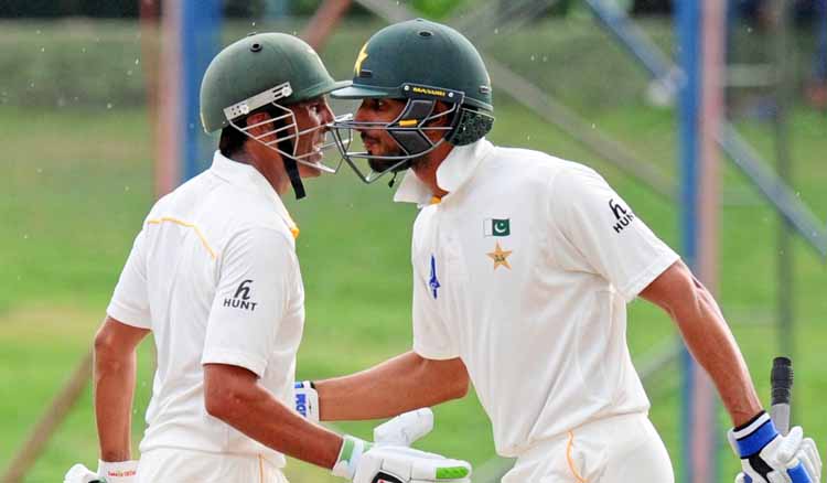 Pakistanu0092s Younis Khan (left) congratulates Shan Masood after his half-century against Sri Lanka during the fourth day of their third Test match in Pallekele on Monday. Photo: AFP