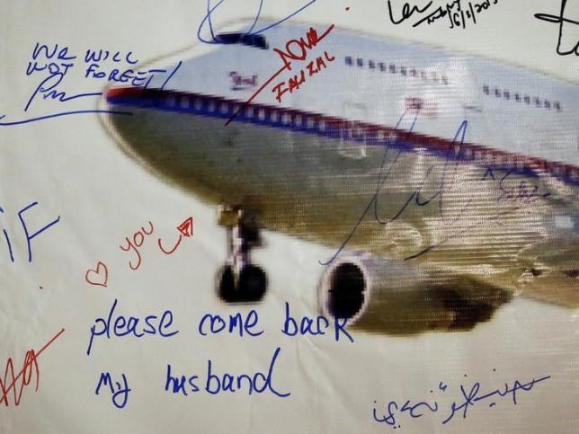 A message left on a board of remembrance by Kelly (last name not given), 29, the wife of a passenger aboard missing Malaysia Airlines Flight MH370, at a vigil ahead of the one-year anniversary of its disappearance in Kuala Lumpur, March 6, 2015. REUTERS/Olivia Harris/Files