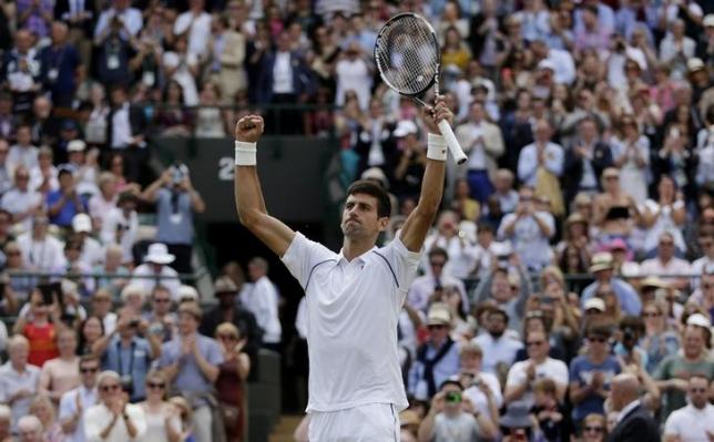 Novak Djokovic of Serbia celebrates after winning his match against Kevin Anderson of South Africa at the Wimbledon Tennis Championships in London, July 7, 2015.                       REUTERS/Henry Browne