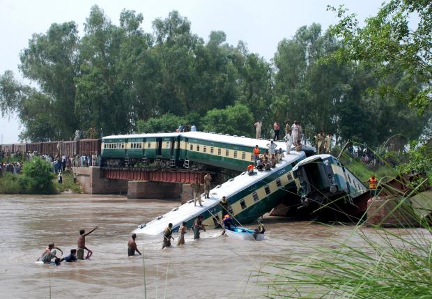 Pakistan Army soldiers and rescue workers conduct search operations at the site after a train fell in a canal near Gujranwala, Pakistan, July 2, 2015. REUTERS/Stringer