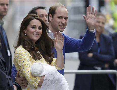 FILE - In this file photo dated Saturday, May 2, 2015, showing Britain's Prince William and Kate, Duchess of Cambridge with their newborn baby, Princess Charlotte Elizabeth Diana, waving to the public as they leave St. Mary's Hospital in London. AP