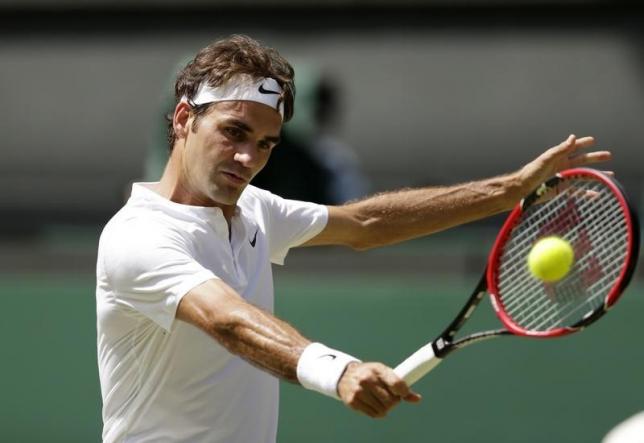 Roger Federer of Switzerland hits a shot during his match against Samuel Groth of Australia at the Wimbledon Tennis Championships in London, July 4, 2015. REUTERS/Henry Browne