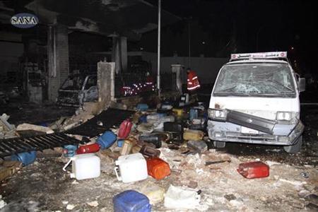 Wreckage and debris are seen after a car bomb exploded at a crowded petrol station in Barzeh al-Balad district in Damascus, in this handout photograph released by Syria's national news agency SANA on January 3, 2013. REUTERS/Sana