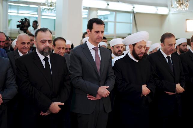 Syria's President Bashar al-Assad (2nd L) attends Eid al-Fitr prayers at al-Hamad mosque in Damascus, Syria, in this handout released by Syria's national news agency SANA on July 17, 2015.  REUTERS/SANA/Handout via Reuters