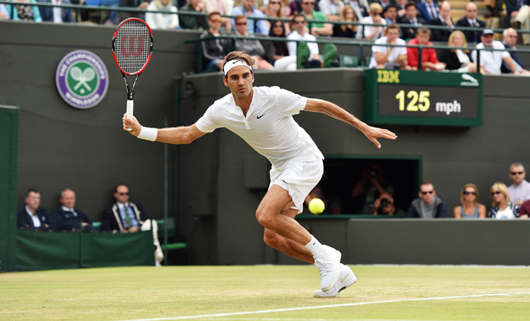 Switzerland's Roger Federer returns to France's Gilles Simon during their men's quarter-finals match of the 2015 Wimbledon Championships at the All England Tennis Club in Wimbledon, London on Wednesday. Photo: AFP