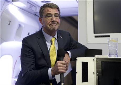 FILE - In this Wednesday, July 22, 2015, file photo, U.S. Defense Secretary Ash Carter pauses as he speaks with media on a military aircraft after departing Jiddah, Saudi Arabia, en route Amman, Jordan. Carter arrived unannounced in Baghdad on Thursday, July 23, 2015, to assess the governmentu2019s progress in healing the countryu2019s sectarian divisions and hear the latest on support for the Iraqi armyu2019s coming attempt to recapture the key city of Ramadi from the Islamic State. AP