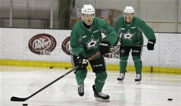 Wonjun Kim, left, of South Korea, takes a puck in front of fellow South Korean Jinhui Ahn during a Dallas Stars development hockey camp at the team's practice facility in Frisco, Texas, Thursday, July 9, 2015. South Korean players from the Asia League Ice Hockey are working out with the Stars.  Photo: AP