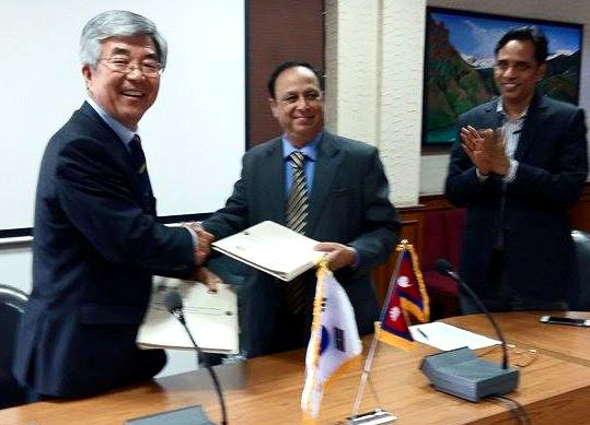 Korean Ambassador to Nepal Choe Yong-jin and Finance Secretary Suman Prasad Sharma exchange the agreement at the Ministry of Finance, in Kathmandu, on Friday, July 24, 2015. Photo: KOICA