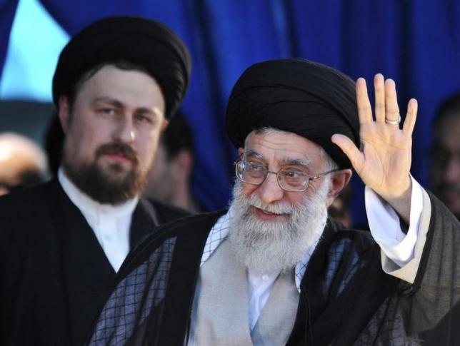 Iran's Supreme Leader Ayatollah Ali Khamenei (R) waves to his supporters as Hassan Khomeini, grandson of Iran's Late Leader Ayatollah Ruhollah Khomeini, looks on during a ceremony to mark the death anniversary of the Islamic Republic founder Ayatollah Khomeini at Khomeini's shrine in southern Tehran June 4, 2010. REUTERS/IIPA/Sajjad Safari/Files