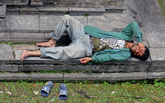 A man enjoying his siesta outside a temple on the premises of Pashupatinath, in Kathmandu, on Sunday. Photo: THT