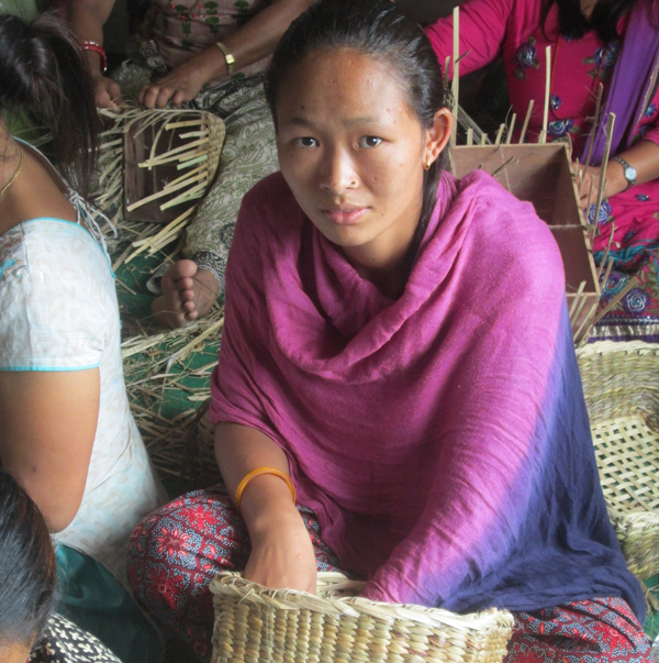 Tremor victim Sarita Gurung of Laprak VDC knitting a wicker basket, in Gorkha, on Wednesday. Photo: THT