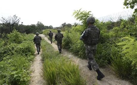 In this Aug. 9, 2015, photo provided by the Defense Ministry, South Korean army soldiers patrol near the scene of a blast inside the demilitarized zone in Paju, South Korea. Vowing to hit back, South Korea said Monday, Aug. 10, 2015, that North Korean soldiers laid the three mines that exploded last week at the border and maimed two South Korean soldiers. Photo:Reuters