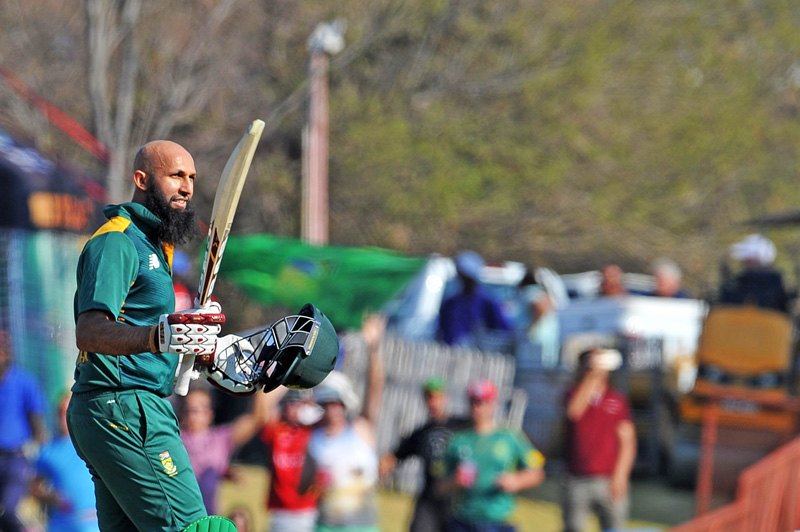 South Africau0092s Hashim Amla celebrates after scoring a century against New Zealand during the first ODI match in Pretoria on Wednesday. Photo: AFP