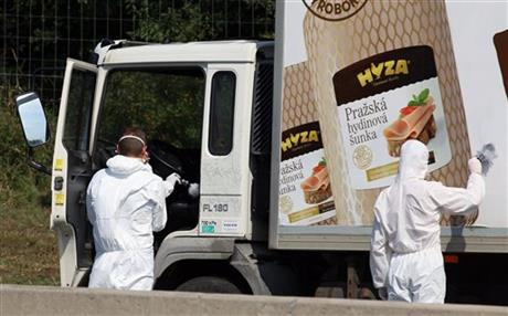Investigators search traces at a truck that stands on the shoulder of the highway A4 near Parndorf south of Vienna, Austria, Thursday, Aug 27, 2015. AP