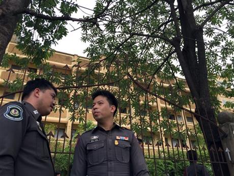 Thai police stand outside an apartment building in Nong Jok on the outskirts of Bangkok, Thailand on Saturday, Aug. 29, 2015. Thai police say they arrested a suspect in the blast at the Erawan Shrine on Aug. 17 in this apartment building on Saturday. AP