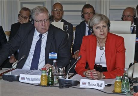 British Transport Secretary Patrick McLoughlin, left, and Home Secretary Theresa May, attend an emergency meeting on train security in Paris, France, Saturday, Aug. 29, 2015. AP