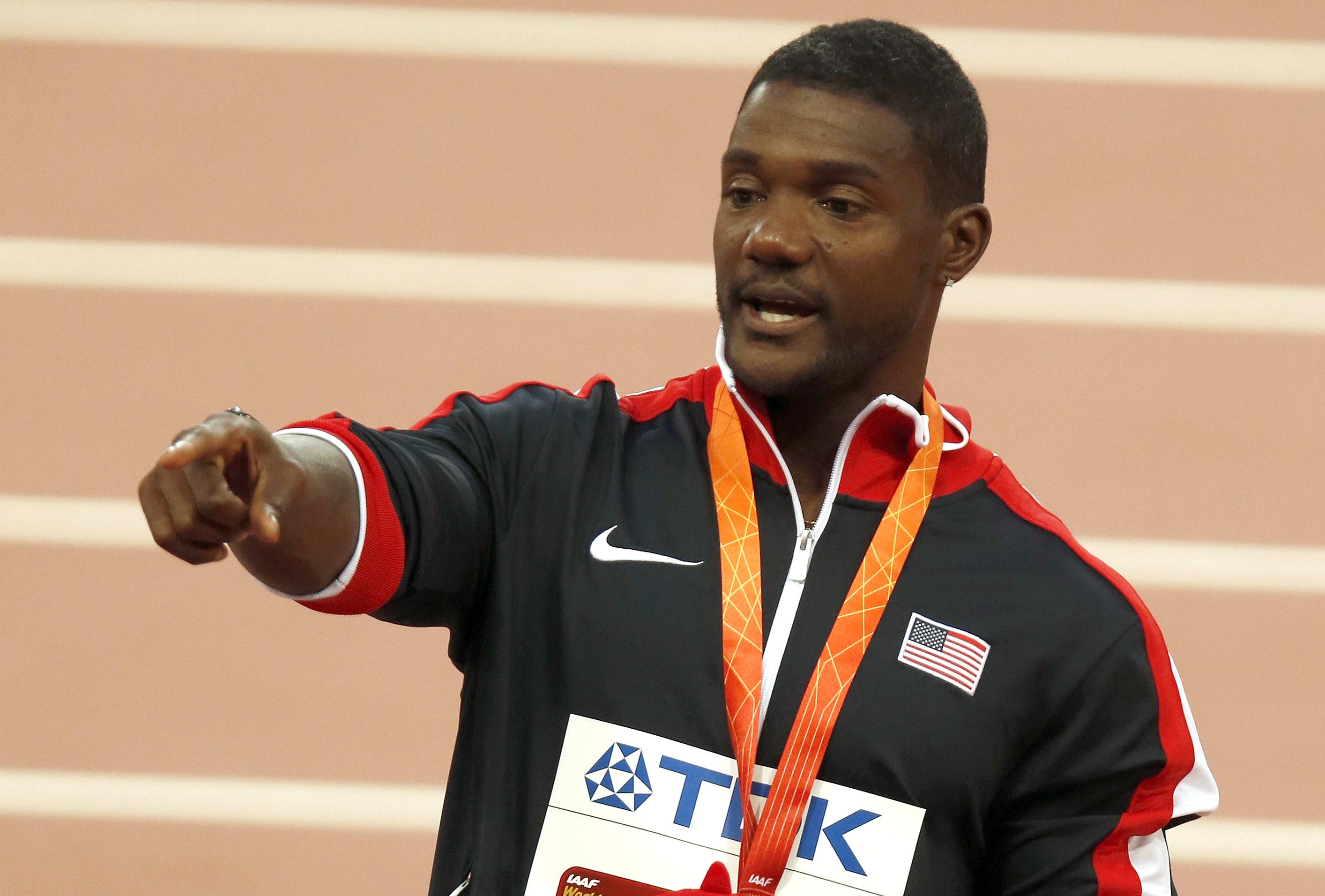 Silver medalist Justin Gatlin of the United States points to the crowd during the medal ceremony for the menu0092s 100m final at the World Athletics Championships at the Bird's Nest stadium in Beijing, Monday, Aug. 24, 2015.  Photo: AP