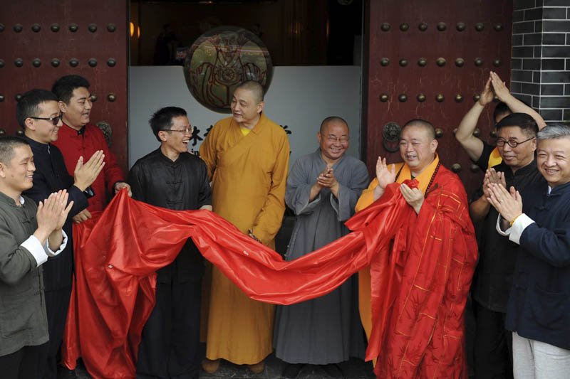 In this photo taken Sunday June 28, 2015, Shi Yongxin, third from right in yellow and red robes, abbot of the Shaolin Temple, attends the opening ceremony of an urban zen center named Shaolin Chan Hall in Xi'an in northwest China's Shaanxi province. Photo: AP
