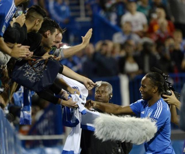 Aug 5, 2015; Montreal, Quebec, CAN; Montreal Impact forward Didier Drogba (11) signs autographs at the half at Stade Saputo. Mandatory Credit: Eric Bolte-USA TODAY Sports