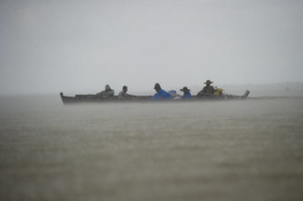 Residents commuting on a boat through floodwaters as heavy rains hit Kyouk Ye village near Hinthada town in Myanmar's Irrawaddy region, on Thursday. Phoato:AFP