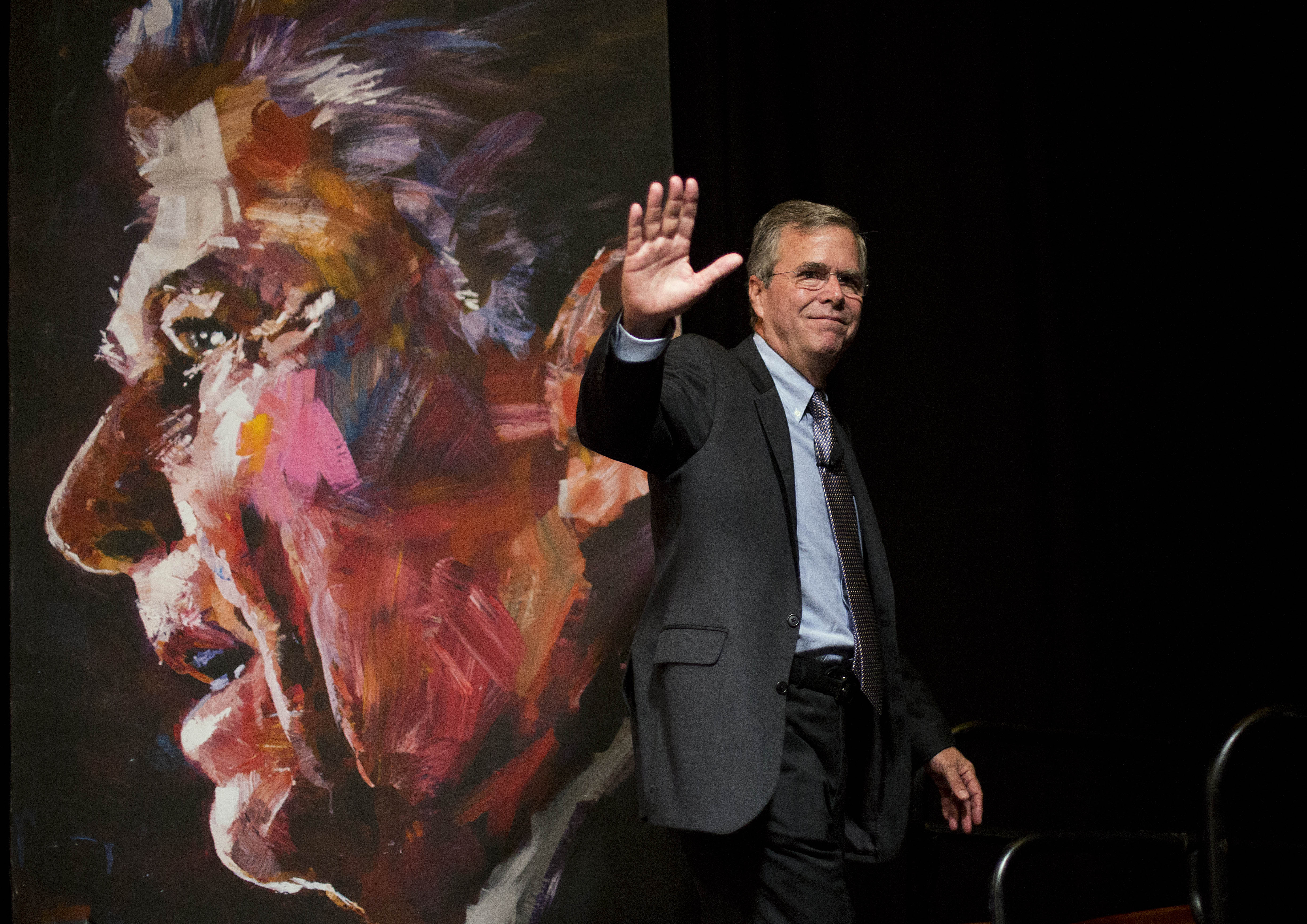 Republican presidential candidate Jeb Bush waves to the crowd while walking past a portrait of former President Ronald Reagan after speaking at the RedState Gathering Saturday, August 8, 2015, in Atlanta. Photo: AP 