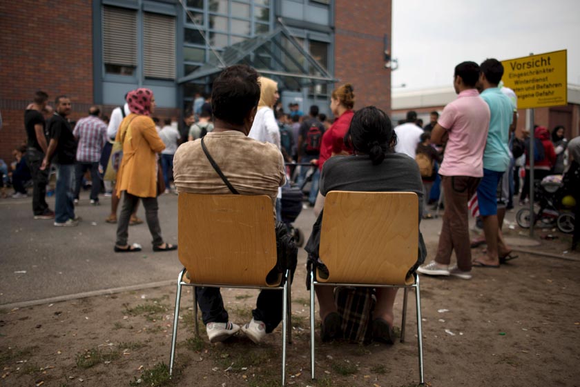 Asylum seekers wait in front of the Federal Office for Migration and Refugees (BAMF) at Berlin's Spandau district, Germany August 17, 2015. Photo: Reuters