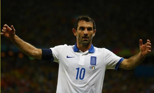 Greece's Giorgos Karagounis (10) reacts after Ivory Coast scored their first goal during their 2014 World Cup Group C soccer match at the Castelao arena in Fortaleza June 24, 2014. REUTERS/Paul Hanna/Files