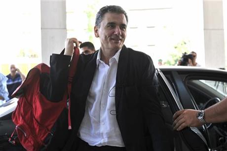 In this Friday, July 31, 2015 file photo, Greek Finance Minister Euclid Tsakalotos arrives for a meeting with senior negotiators at a hotel in Athens. AP