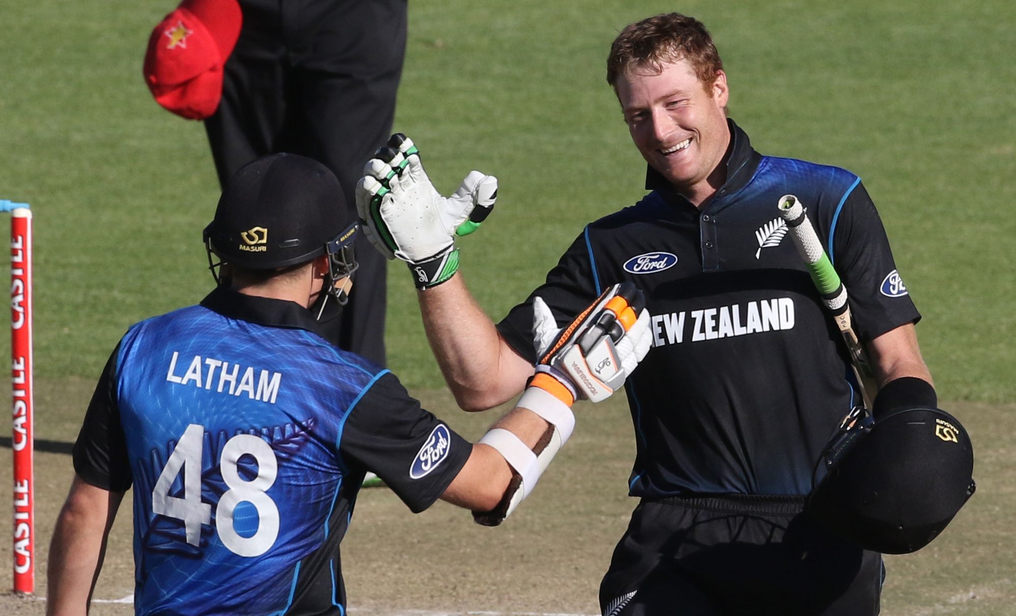 New Zealand's Martin Guptill (right) celebrates with his teammate Tom Latham after scoring a century against Zimbabwe during their second ODI match in Harare on Tuesday. Photo: AFP